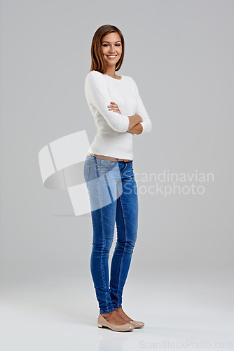 Image of Portrait, confidence and happy woman in studio for fashion isolated on a white background mockup space. Arms crossed, young person and student in casual clothes, jeans or trendy style in Argentina