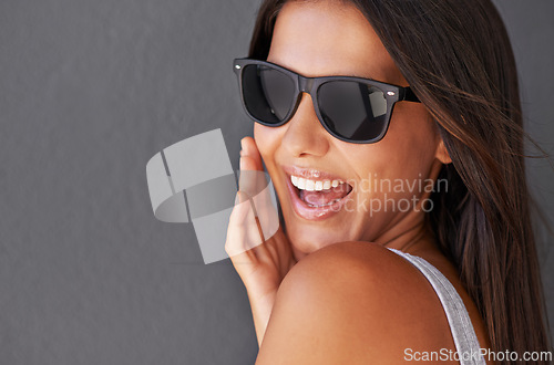 Image of Fashion, mockup or woman in sunglasses laughing in studio on grey background for cool eyewear or style. Trendy model, happy lady or funny person isolated with stylish accessory, smile or edgy shades