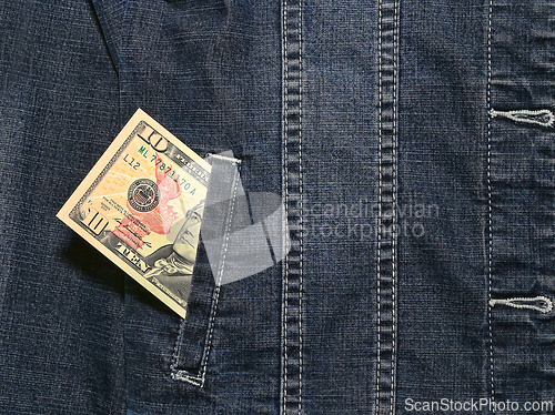 Image of Ten american dollars in a pocket of a denim jacket