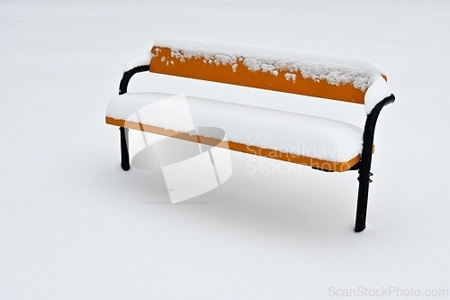 Image of bench covered with snow, minimalist photography 