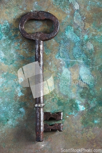 Image of old rusty big key key on copper surface