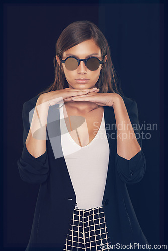 Image of Studio, fashion and portrait of woman with sunglasses stylish for cool, edgy and trendy style with confidence. Serious, elegant and female model on black background with pride from Australia