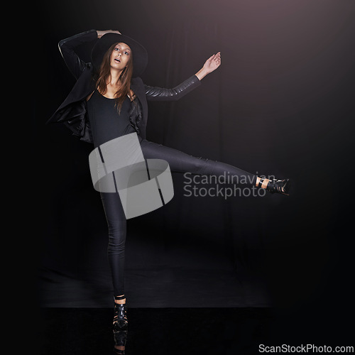 Image of Portrait, fashion and balance with woman on black background in studio for clothing dance. Leather, model and outfit with confident young person in dark clothes for chic, edgy or trendy style