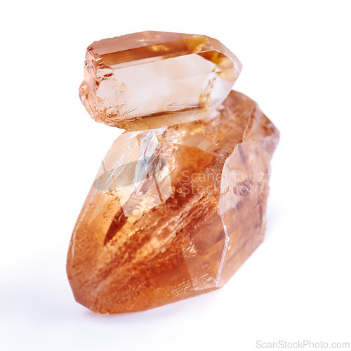 Image of Gem, crystal and orange stone in studio with isolated white background for natural resource, shine and sparkle for luxury. Rock, jewel and reflection in closeup for citrine, glow and mineral