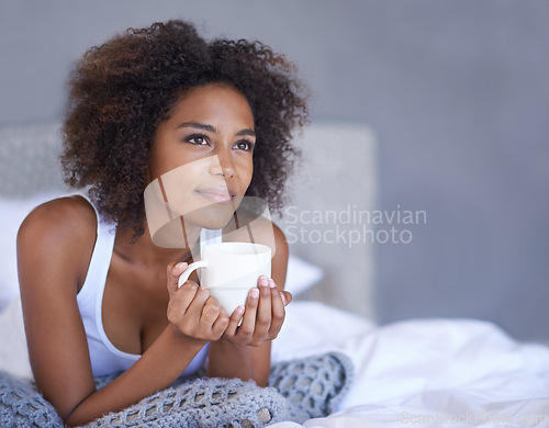 Image of Woman, happy and relax in bedroom with coffee mug, wellness and espresso on morning vacation on home. Young lady, inspiration and cup of tea on lazy weekend, break and peace on bed in cozy apartment