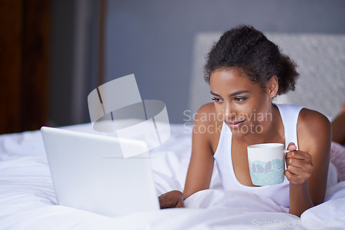 Image of Black woman, computer or tea in bed to relax, scroll or search on internet, social media or network. Female influencer, coffee or laptop as checking, message or email for viral meme and blog post
