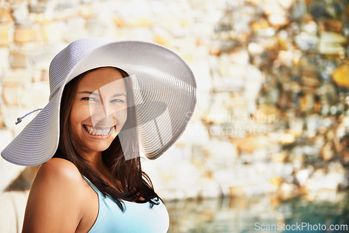 Image of Pool, smile and portrait of woman with sun hat for summer holiday, travel and relax at luxury resort. Happy, female person and vacation at retreat for weekend, break and adventure for wellness