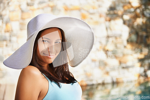 Image of Smile, sun hat and portrait of woman at resort for summer holiday, travel and break by pool. Relax, happy and female person with happiness for vacation, weekend trip or luxury retreat for wellness