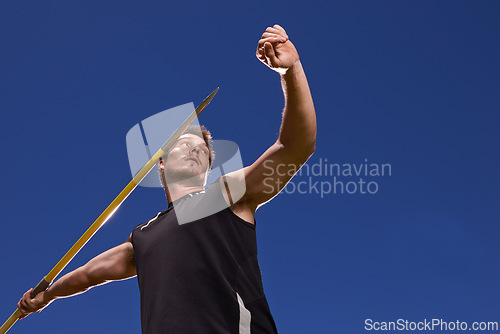 Image of Man, athlete and javelin throw for competition sport with arm strength for performance practice, challenge or blue sky. Male person, stick and target aim or outdoor activity, professional or champion