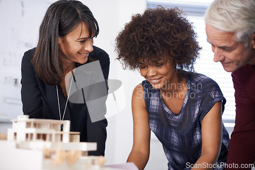 Image of Architecture, civil engineer and meeting with model for construction, property development or floor plan. Infrastructure, design and diverse group of people in collaboration, teamwork and planning