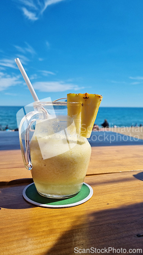 Image of Pitcher of liquid on wooden table