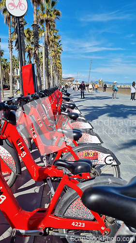 Image of BARCELONA, SPAIN - APRILL 2, 2024: Row of red bikes parked
