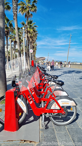 Image of BARCELONA, SPAIN - APRILL 2, 2024: Row of bikes parked on sidewalk