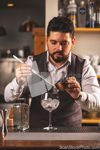 Image of Professional bartender preparing a cocktail