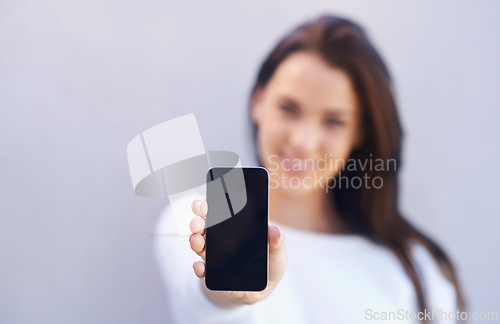 Image of Mockup, person and smartphone on gray background with screen for connectivity, communication and mobile with technology. Studio, cellphone and interaction with internet for chat or conversation