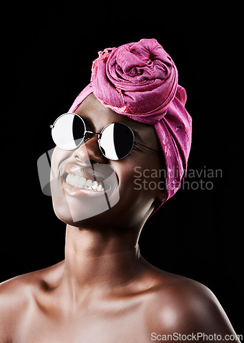 Image of Face, turban and smile with black woman in studio isolated on dark background for heritage. Fashion, model and sunglasses with confident African person in trendy headwear for traditional style