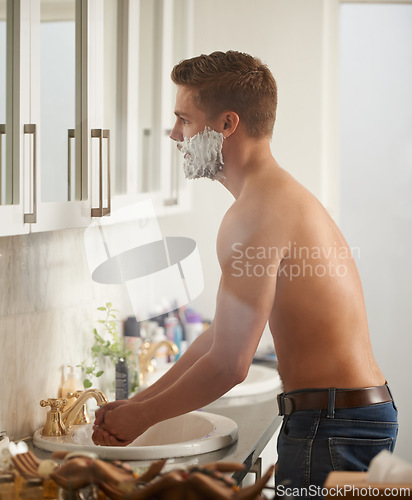 Image of Man, foam for shaving and grooming in bathroom, skincare and beauty with morning routine at sink. Skin health, cosmetic cream or soap for hygiene, dermatology and hair removal with facial at home