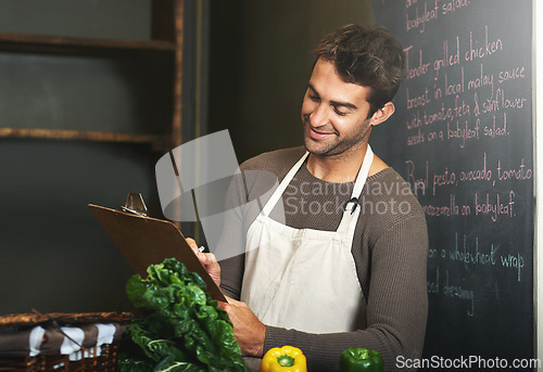 Image of Kitchen, restaurant and man with clipboard for cooking, service and chef skills for supper. Fine dining, cafe and person with notes, paper and write for stock, inventory and ingredients for meal prep