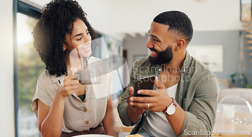 Image of Couple, happy and coffee with smartphone for social media, sharing music or app explanation. Man, woman and technology in kitchen with breakfast for morning, relaxing and scrolling on online website