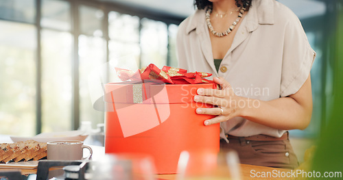 Image of Woman, excited and open gift box in home with surprise, romance and love in marriage on valentines day. Lady, nervous and shake a red present for anniversary, care and gratitude by kitchen counter