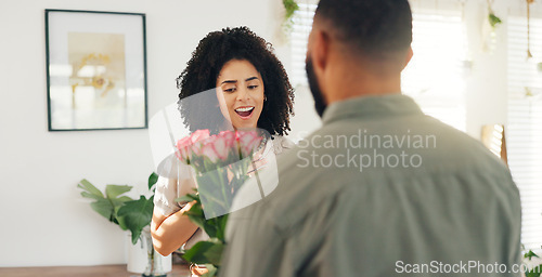 Image of Couple, hug and flowers as surprise for valentines day with love bouquet or relationship, anniversary or behind. Man, woman and embrace in home with roses for marriage or date, celebration or present