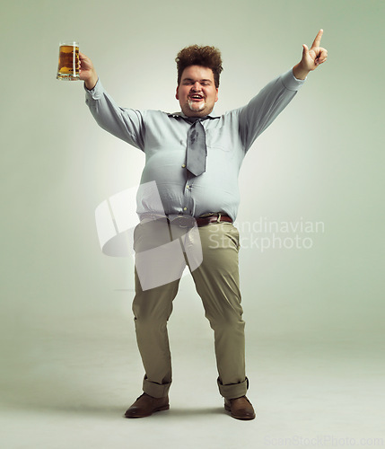 Image of Happy man, portrait and celebration with beer for party or obesity on a studio background. Young male person or plus size model with glass, mug or alcohol in satisfaction for booze on mockup space