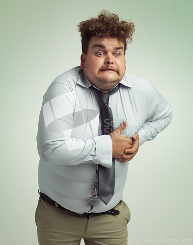 Image of Frustrated man, plus size and heart attack with cardiac arrest or ache on a studio background. Male person or model with pain, body fat or cholesterol in obesity, unhealthy or overweight on mockup