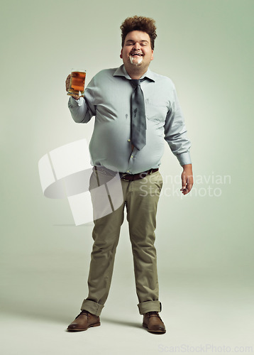 Image of Man, portrait and drinking with beer foam in party or obesity on a studio background. Young male person or plus size model with glass, mug or alcohol in satisfaction for wine or booze on mockup space