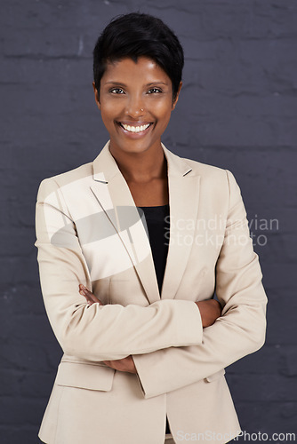 Image of Indian woman, arms crossed and corporate professional with smile, pride and ambition with confidence on wall background. Happy in career, job satisfaction in business and real estate agent in Mumbai