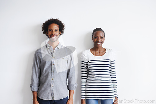 Image of Couple, smile and portrait by white wall in fashion with confidence, casual style and model aesthetic. Black woman, and face of man with trendy apparel, edgy clothes and pride with happiness or relax