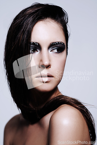 Image of Woman, smokey and eyes with makeup in studio for art and beauty, thinking and wondering with thoughts for cosmetics. Female person, isolated and white background with eyeshadow or cosmetology.