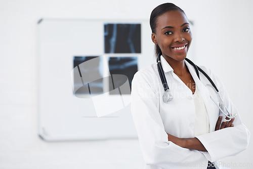 Image of Portrait, healthcare and female doctor with xray, smile and radiology in hospital. Medical, wellness or arms crossed for physician from Nigeria, bone or anatomy with stethoscope for assessment