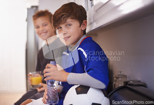 Image of Children, portrait and soccer ball as friends in home with drink for sports training in kitchen for exercise, workout or juice. Male people, athlete and face in apartment with water, cardio or kit