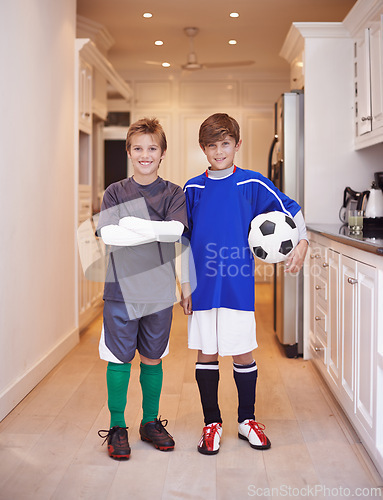 Image of Children, friends and portrait with soccer ball at house or training game in kit or competition, cardio or apartment. Male people, face and football in kitchen or player practice, exercise or workout