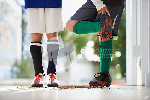 Image of Soccer player, friends and cleats or sports athlete with dirt in home or competition game, workout or training. People, legs and fitness fit in house or football exercise as youth, cardio or practice