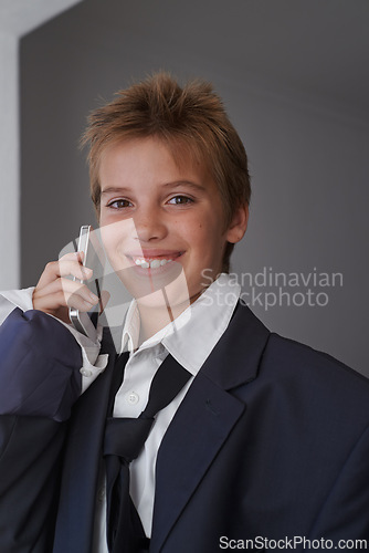 Image of Portrait, child and pretend suit on boy, smartphone or business call for dream job or dress up on kid. Smile, happy in clothes on career day for school, talk on communication technology with costume