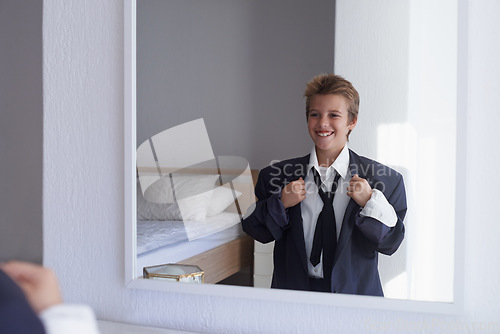 Image of Happy, boy and pretend suit on male person, business wear for dream job or dress up on kid. Smile, clothes for career aspirations day in school, costume and standing in bedroom mirror in home