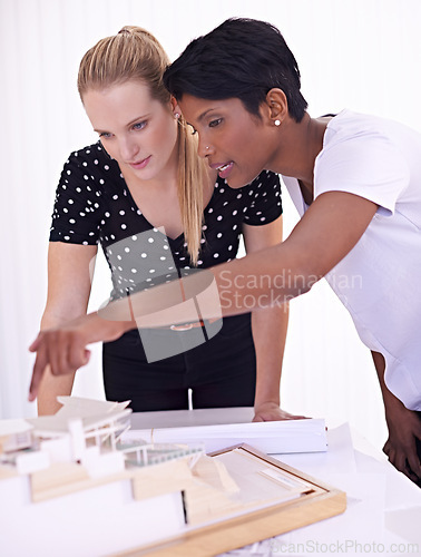 Image of Model, blueprint or people with engineering teamwork for development project or planning on paper. Architecture, women or group of designers talking in collaboration for floor plan of office building