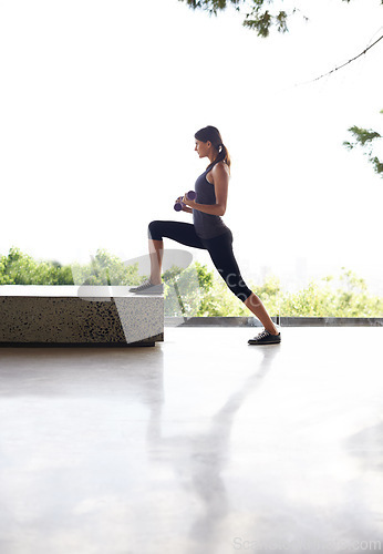 Image of Gym, woman and workout with dumbbell to exercise for healthy living or fitness, committed and focus in Los Angeles. Female person, house and weights for training with wellbeing and self care.