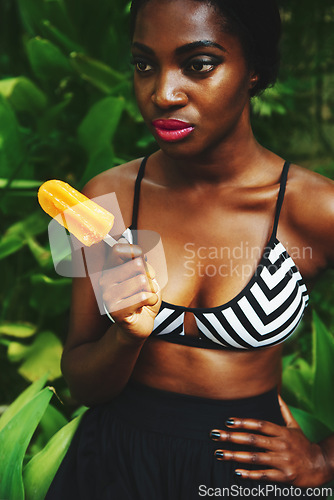 Image of Black woman, fashion and style with popsicle in garden with confidence for glamour, bra and summer outfit. Female person, clothes and trendy look in outdoor on hot weather for edgy and modern.