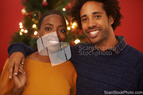 Image of Christmas, tree and portrait of black couple with love in home on holiday or hug on vacation with happiness. Festive, event and people embrace with care and support or excited to celebrate together