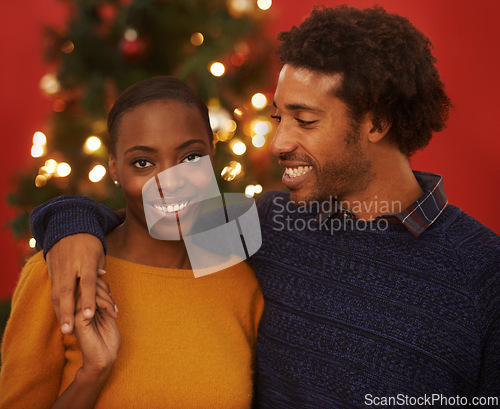 Image of Christmas, tree and portrait of black couple with love in home on holiday or hug on vacation with happiness. Festive, event and people embrace with care and support or excited to celebrate together