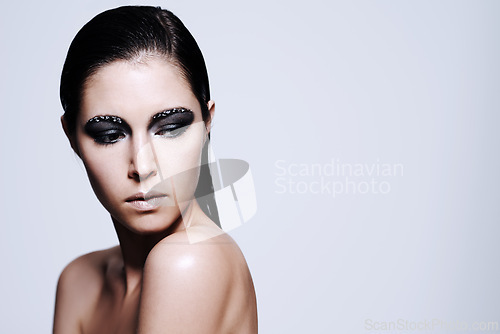 Image of Woman, smokey and eyeshadow with makeup in studio for art and beauty, thinking and wondering with thoughts for cosmetics. Female person, isolated and white background, mockup space and glamour