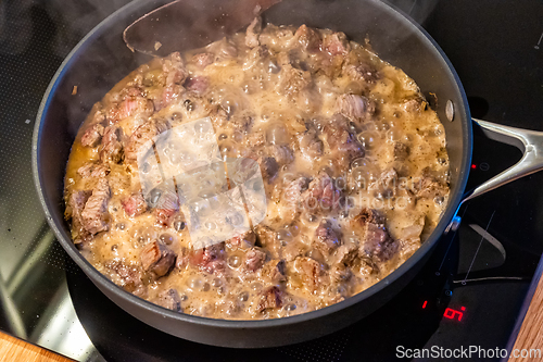 Image of the meat is stewed in a pan