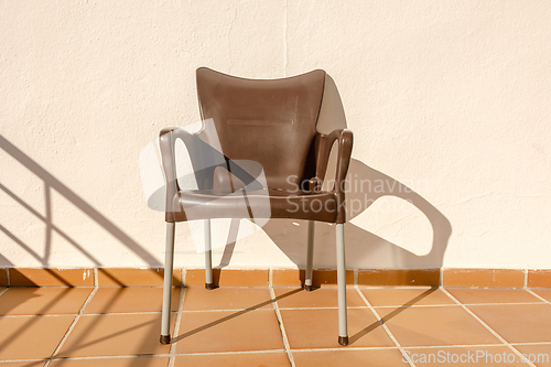 Image of brown plastic chair on the apartment terrace