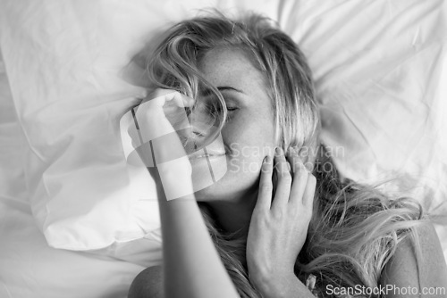 Image of Top view, sleeping and woman on pillow in bed to relax, peace and calm in the morning. Face, above and young person in bedroom to rest, comfort and lying in home on black and white sheets in house