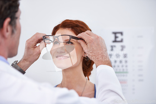 Image of Man, optician and patient with glasses for eye exam consultation or healthy vision, retina or testing. Male person, woman and eyewear conversation for wellness checkup or advice, prescription or care