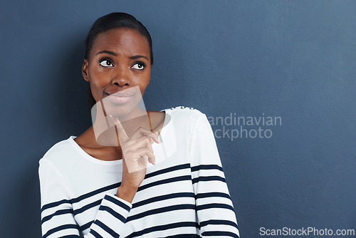 Image of Thinking, doubt and black woman with mockup in studio for planning, questions or asking on blue background. Why, curious or African female model with emoji guess, problem solving or brainstorming