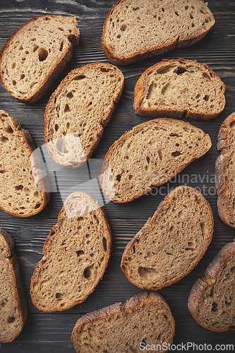 Image of Artisan sliced bread on wooden surface