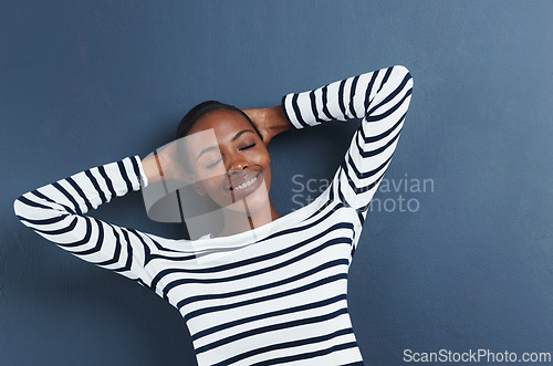 Image of Black woman, happy and eyes closed in studio to relax, peace and fashion top by blue background. African student, break and rest on hands for education, wellness and positive gen z with funky clothes